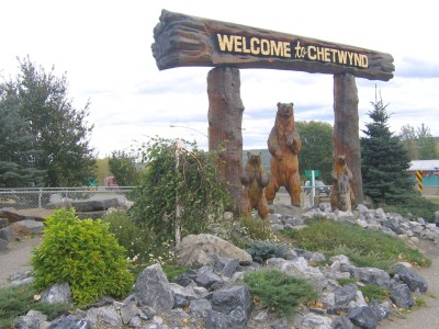 A wooden Welcome to Chetwynd sign with carved wooden bears.