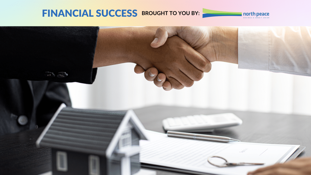 Two people shaking hands over paperwork and a model of a house