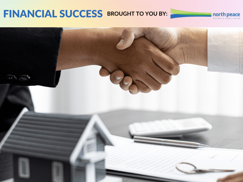 Two people shaking hands over paperwork and a model of a house