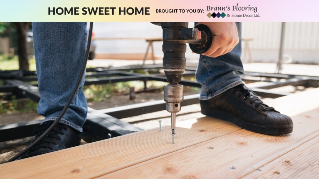 A person drilling into a floorboard