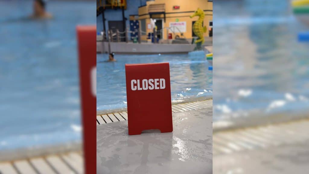 A red closed sign in front of the leisure pool.