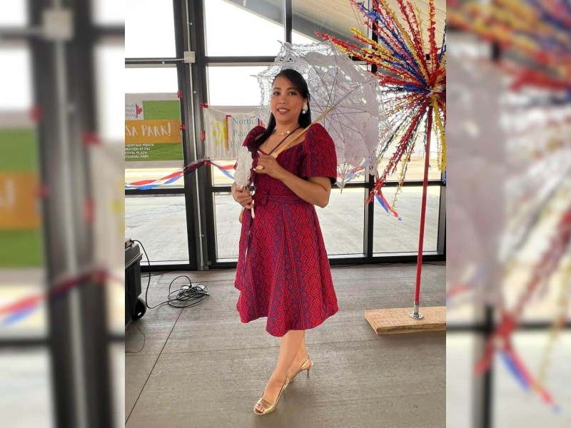 A woman in a red dress and holding a white lace parasol.