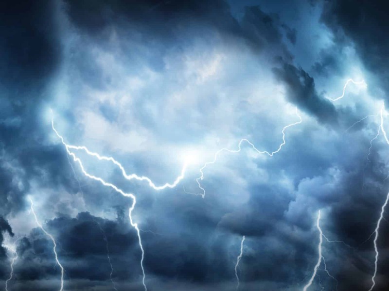 A stock image of a lightning storm and cloudy skies.
