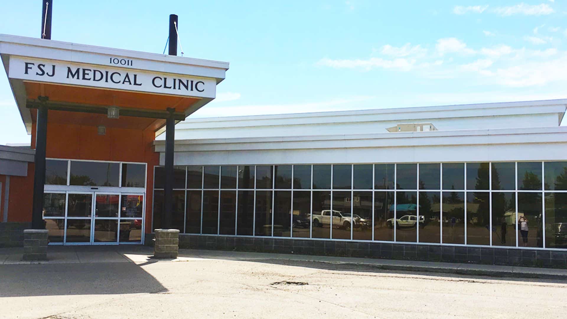 The FSJ Medical Clinic building from the outside, brick building with many mirrored windows.