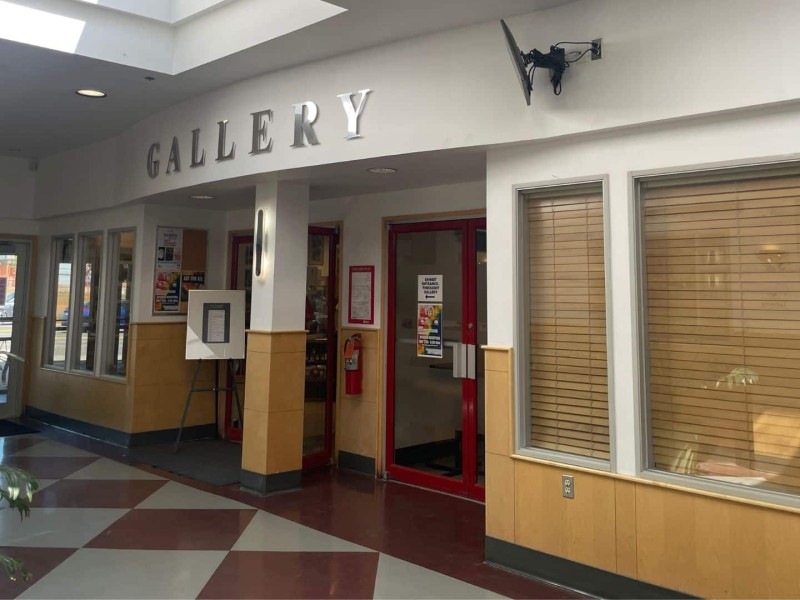 The entrance to Peace Gallery North with gold letters reading "GALLERY" above a set of double doors.