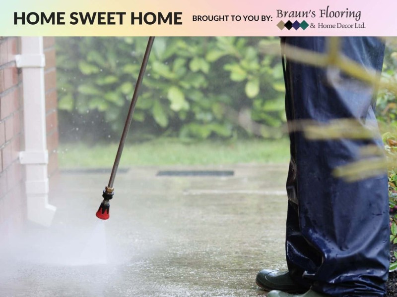 A person pressure washing their house