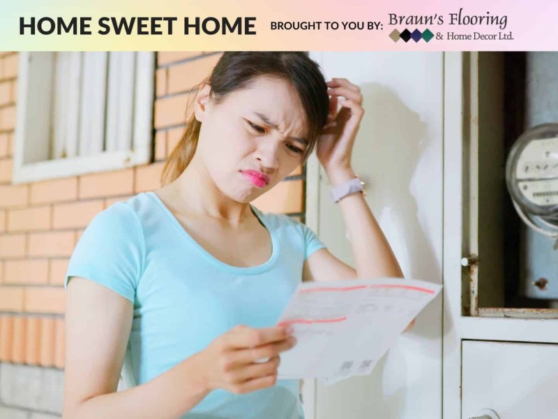 A person looking at a bill visibly confused