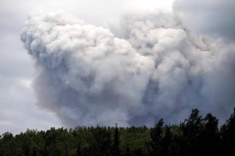 Smoke billows from the Donnie Creek wildfire burning north of Fort St. John, British Columbia, Canada, Sunday, July 2, 2023. (AP Photo/Noah Berger)