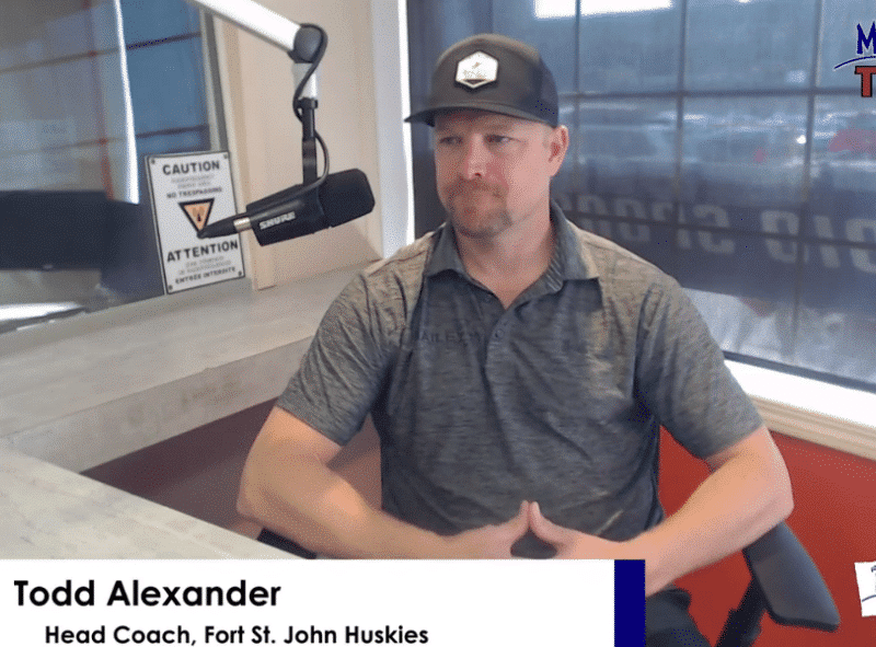 Todd Alexander, the Fort St. John Huskies' head coach, wearing a hat and a grey polo