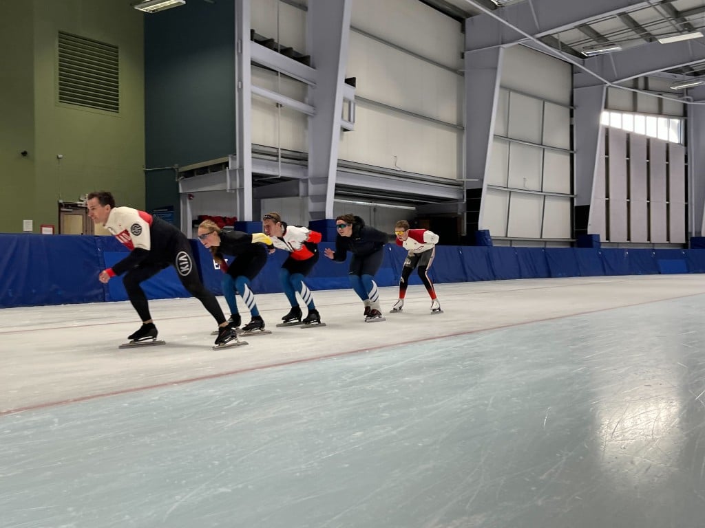 a group of people speed skating