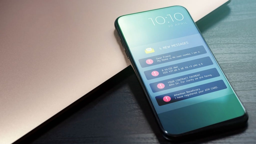 A cell phone with a series of scam text message notifications on the screen.
