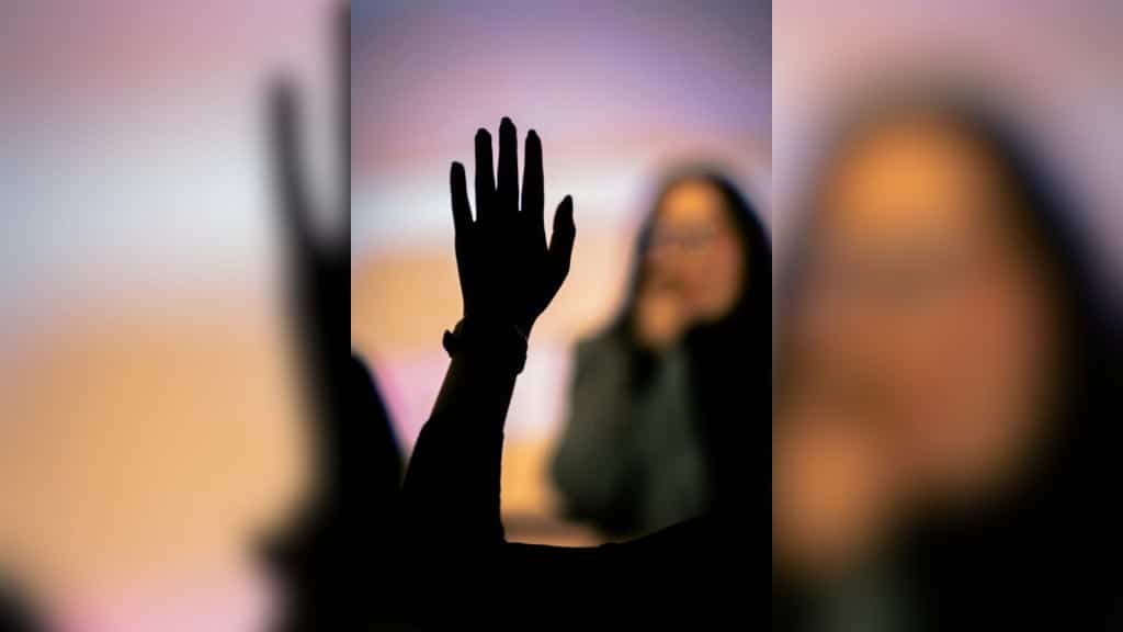 File photo of a person raising their hand to ask a question. 