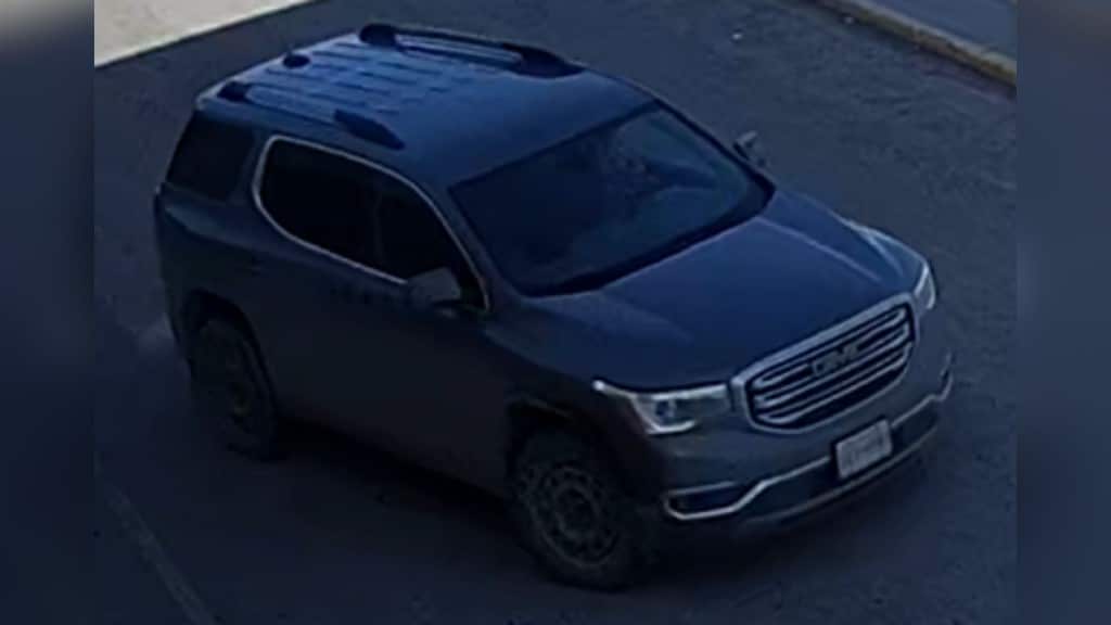A newer model grey GMC Acadia.