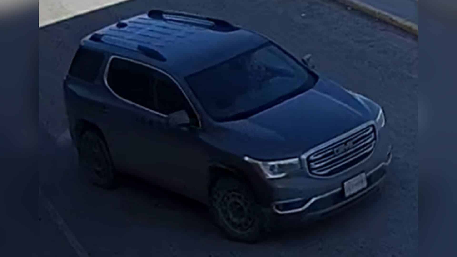 A newer model grey GMC Acadia.