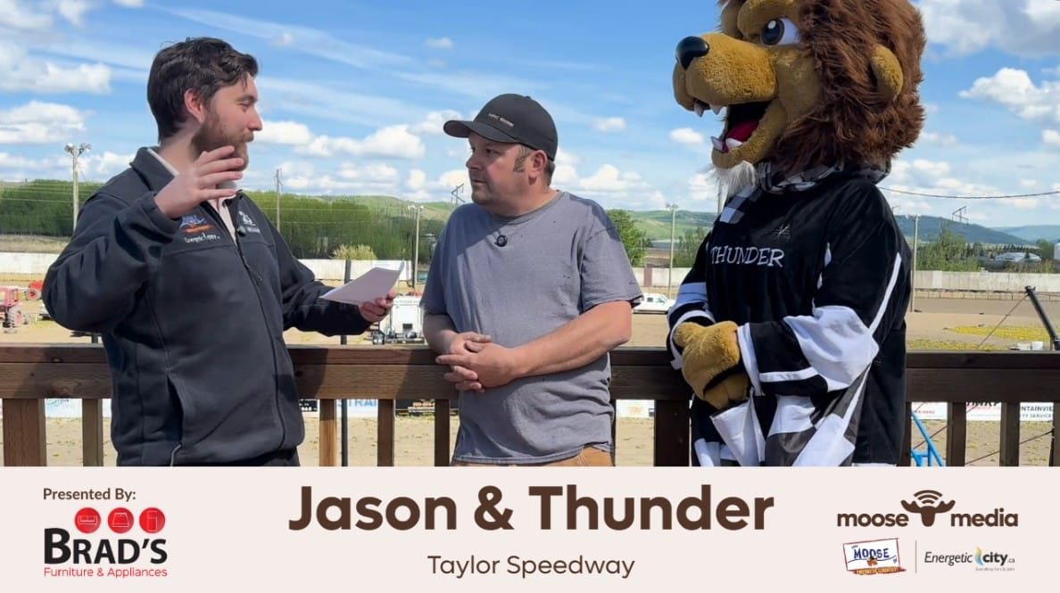 Two people and a mascot smiling at the camera