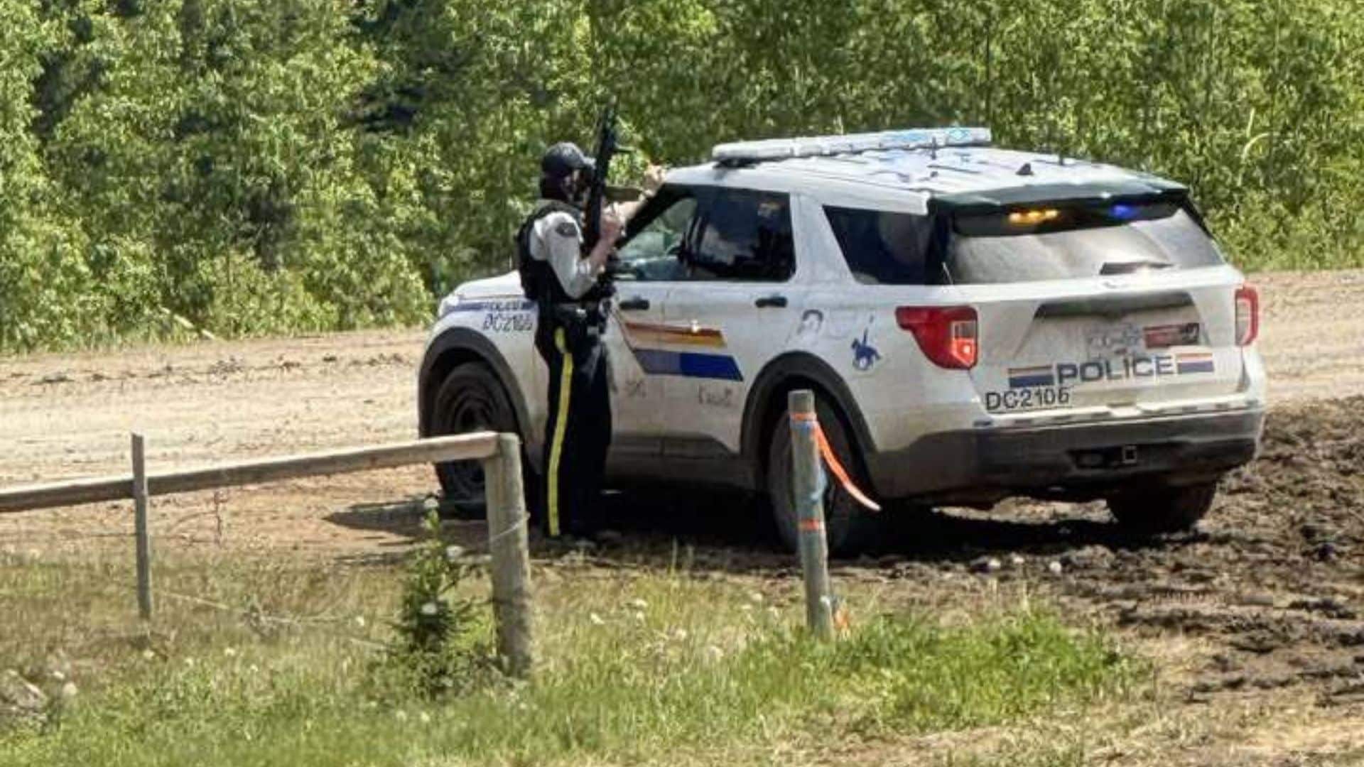 A picture of an armed police officer amid the incident which closed Highway 52. (Submitted)