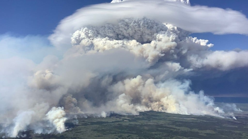 Current image: Smoke billows from the Etcho Creek wildfire north of Fort Nelson. (BCWS)