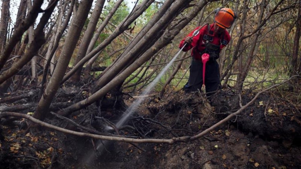 A firefighter tackling the Kiskatinaw River wildfire. (BCWS)