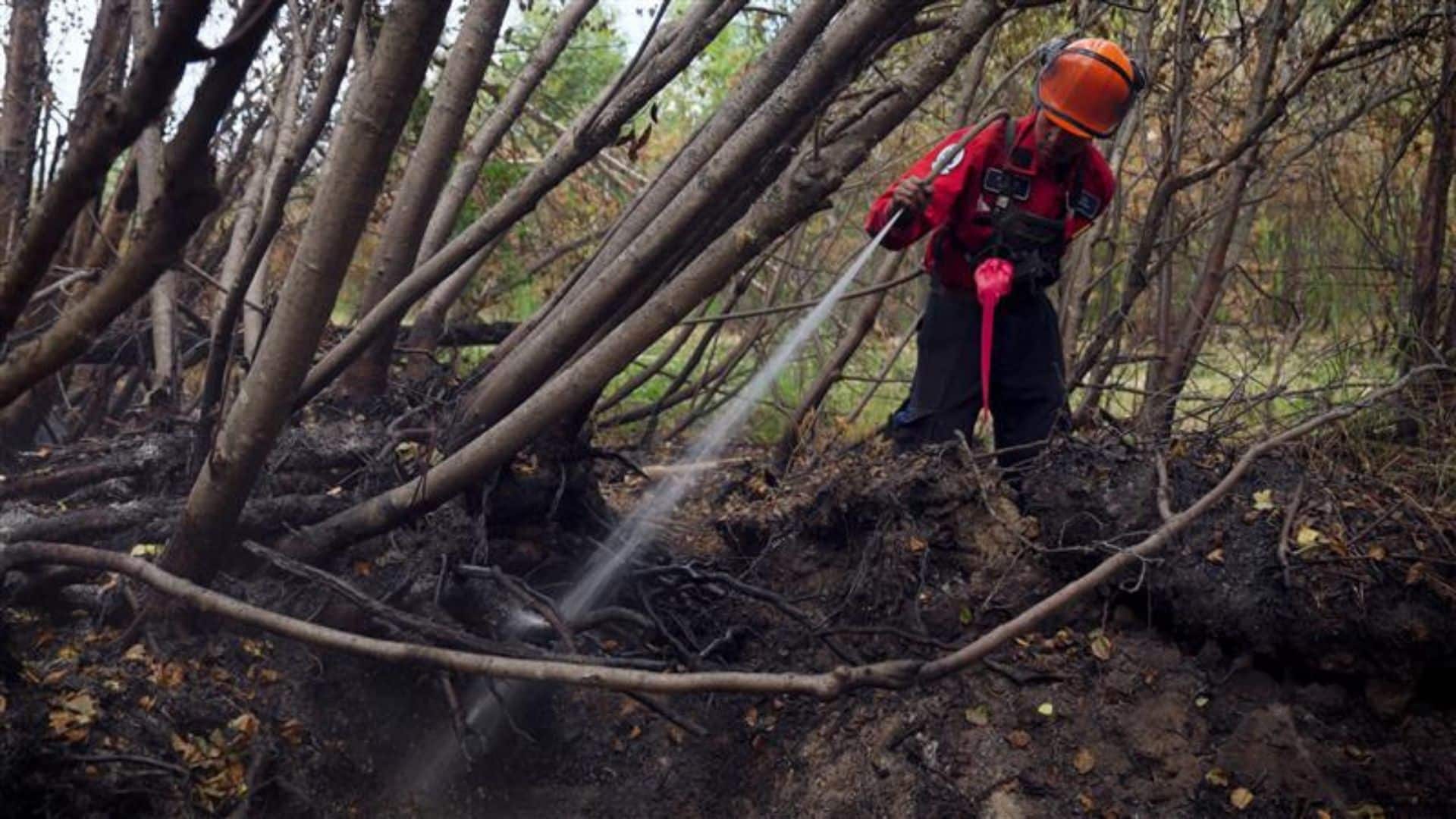 A firefighter tackling the Kiskatinaw River wildfire. (BCWS)