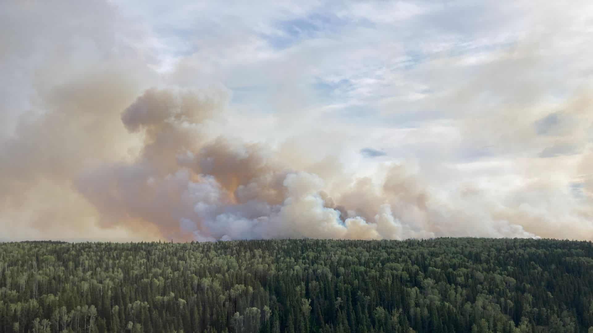 Smoke from a wildfire near the Fort Nelson River which is now 'under control.' (BCWS)