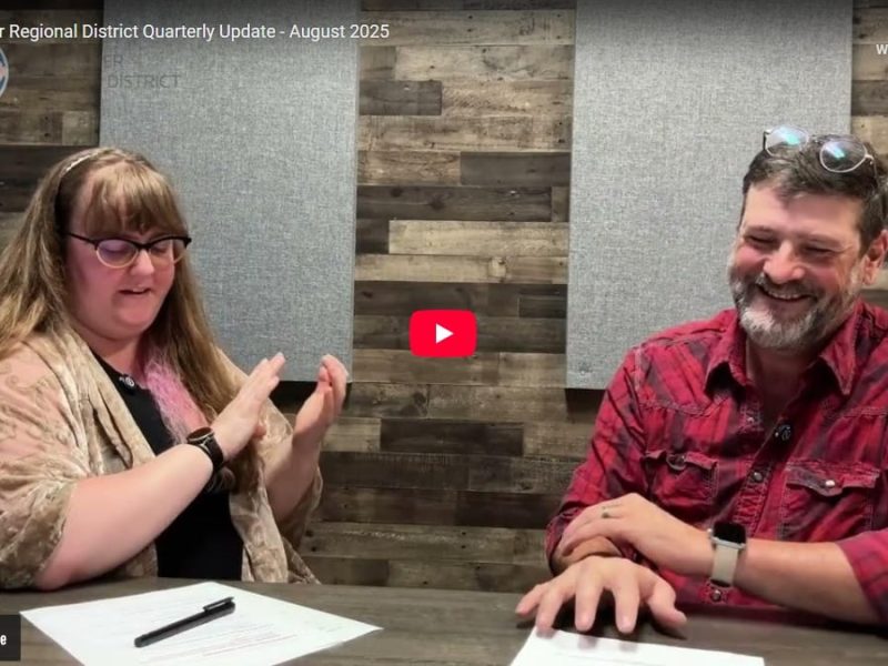 Two people smiling at the camera