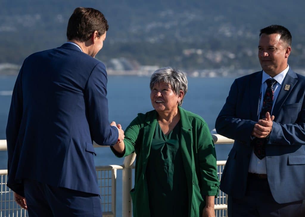 B.C. Premier David Eby shakes hands with Nisga'a Nation President Eva Clayton during a Ksi Lisims LNG announcement of an environmental assessment certificate from the Government of British Columbia in Vancouver, on Tuesday, September 16th, 2025. (THE CANADIAN PRESS/Ethan Cairns)