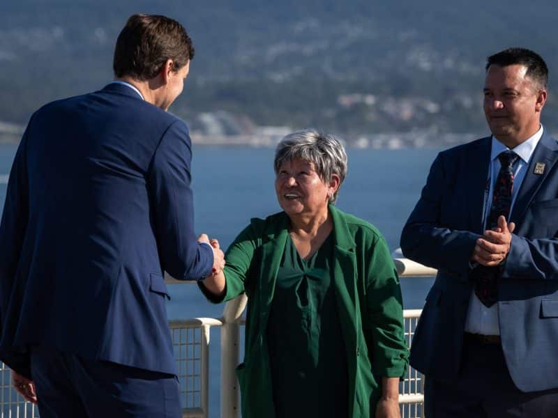 B.C. Premier David Eby shakes hands with Nisga'a Nation President Eva Clayton during a Ksi Lisims LNG announcement of an environmental assessment certificate from the Government of British Columbia in Vancouver, on Tuesday, September 16th, 2025. (THE CANADIAN PRESS/Ethan Cairns)