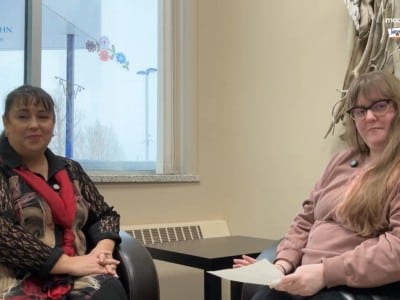 Two people smiling at the camera