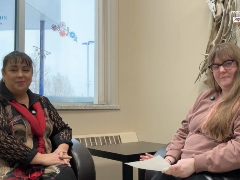 Two people smiling at the camera