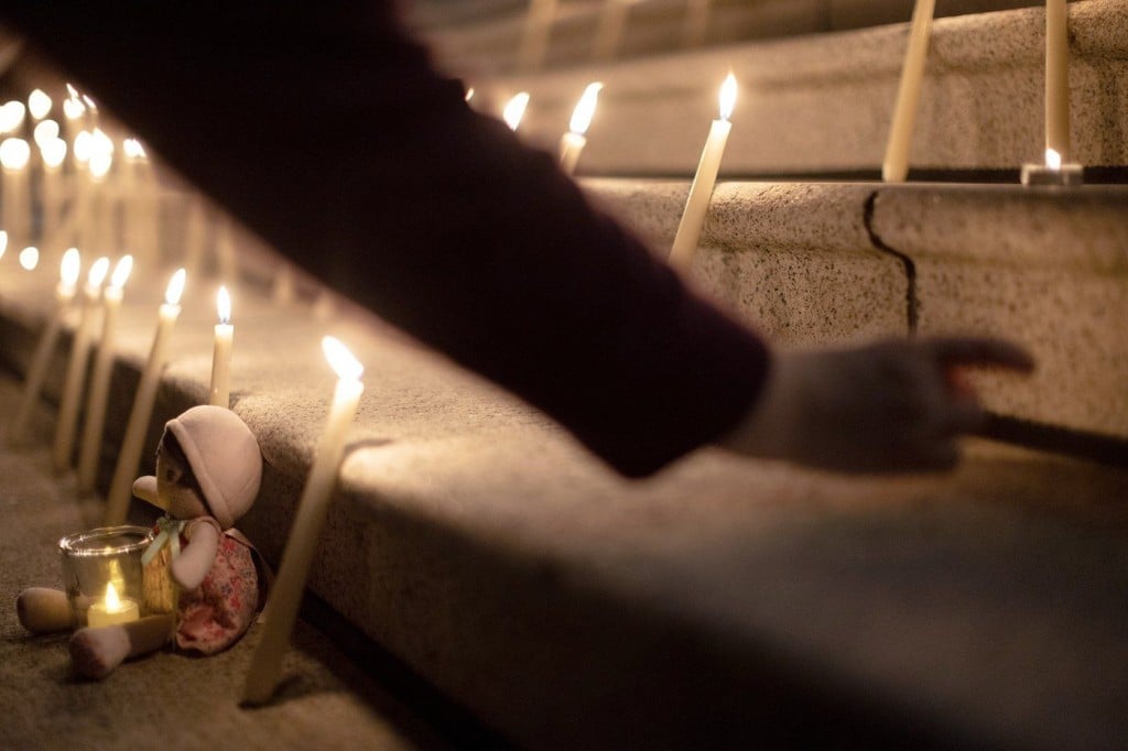 People attend a candle light vigil at the front steps of the legislature in Victoria, B.C., on Wednesday, Feb. 11, 2026 in honour of the victims of the school shooting in Tumbler Ridge, B.C. THE CANADIAN PRESS/Chad Hipolito CHAD HIPOLITO