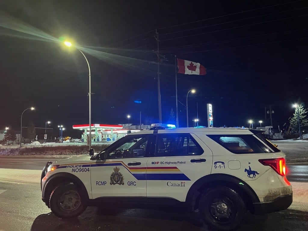 A BC Highway Patrol cruiser parked roadside in slushy, winter conditions near Prince George