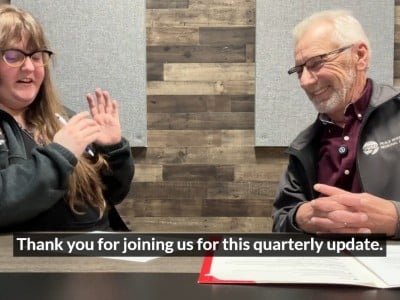 Two people smiling at the camera