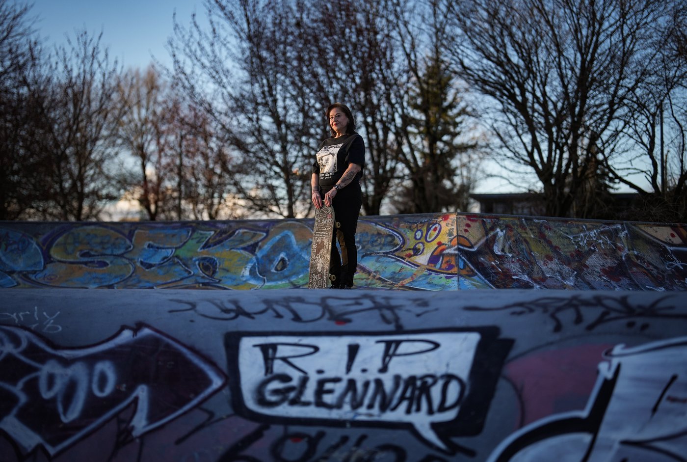 Meredith Dan holds her late son Glenn Rebic's skateboard, while posing for a photograph at the China Creek skate park where he used to skateboard, in Vancouver, on Friday, March 13, 2026. Rebic died of a fentanyl overdose in 2019 at the age of 29. THE CANADIAN PRESS/Darryl Dyck