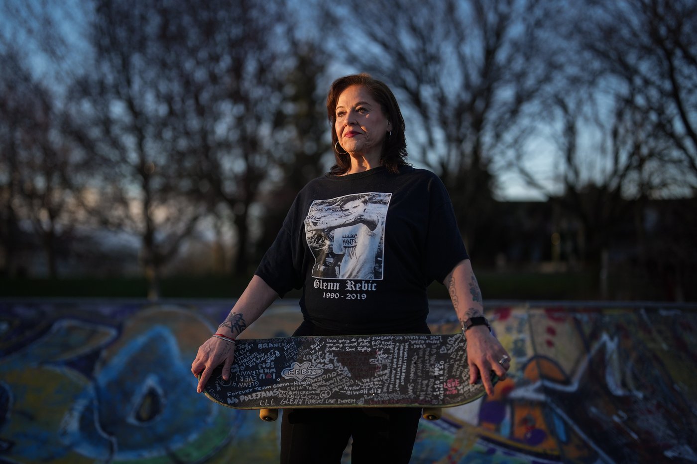Meredith Dan holds her late son Glenn Rebic's skateboard, while posing for a photograph at the China Creek skate park where he used to skateboard, in Vancouver, on Friday, March 13, 2026. Rebic died of a fentanyl overdose in 2019 at the age of 29. THE CANADIAN PRESS/Darryl Dyck