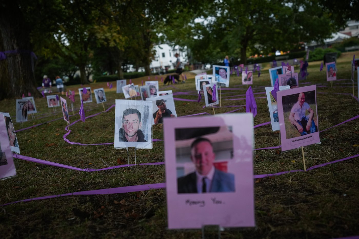 Photographs of overdose victims are displayed as members of Moms Stop the Harm mark International Overdose Awareness Day, in Vancouver, on Thursday, Aug. 31, 2023. THE CANADIAN PRESS/Darryl Dyck