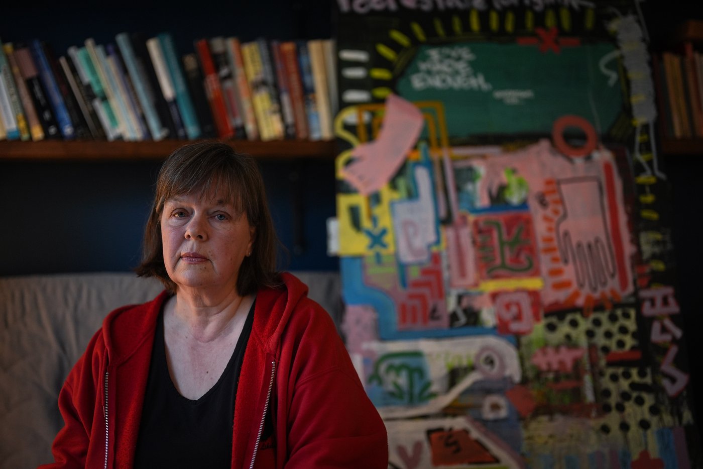 Maria Rantanen sits by artwork painted by her late son Michael Rantanen, who died of a fentanyl overdose in 2022 at the age of 25, while posing for a photograph in Vancouver, on Wednesday, March 18, 2026. THE CANADIAN PRESS/Darryl Dyck