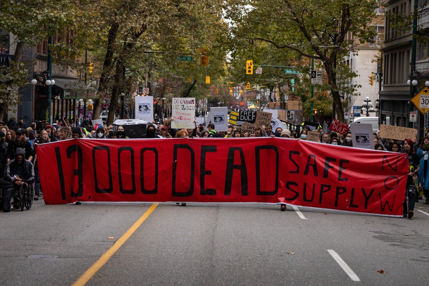 People march down Hastings St. during a rally to condemn the recent arrests of Drug User Liberation Front's (DULF) founders and raids as well as advocating for the continuation of safe supply drugs in Vancouver, on Friday, Nov. 3, 2023. THE CANADIAN PRESS/Ethan Cairns