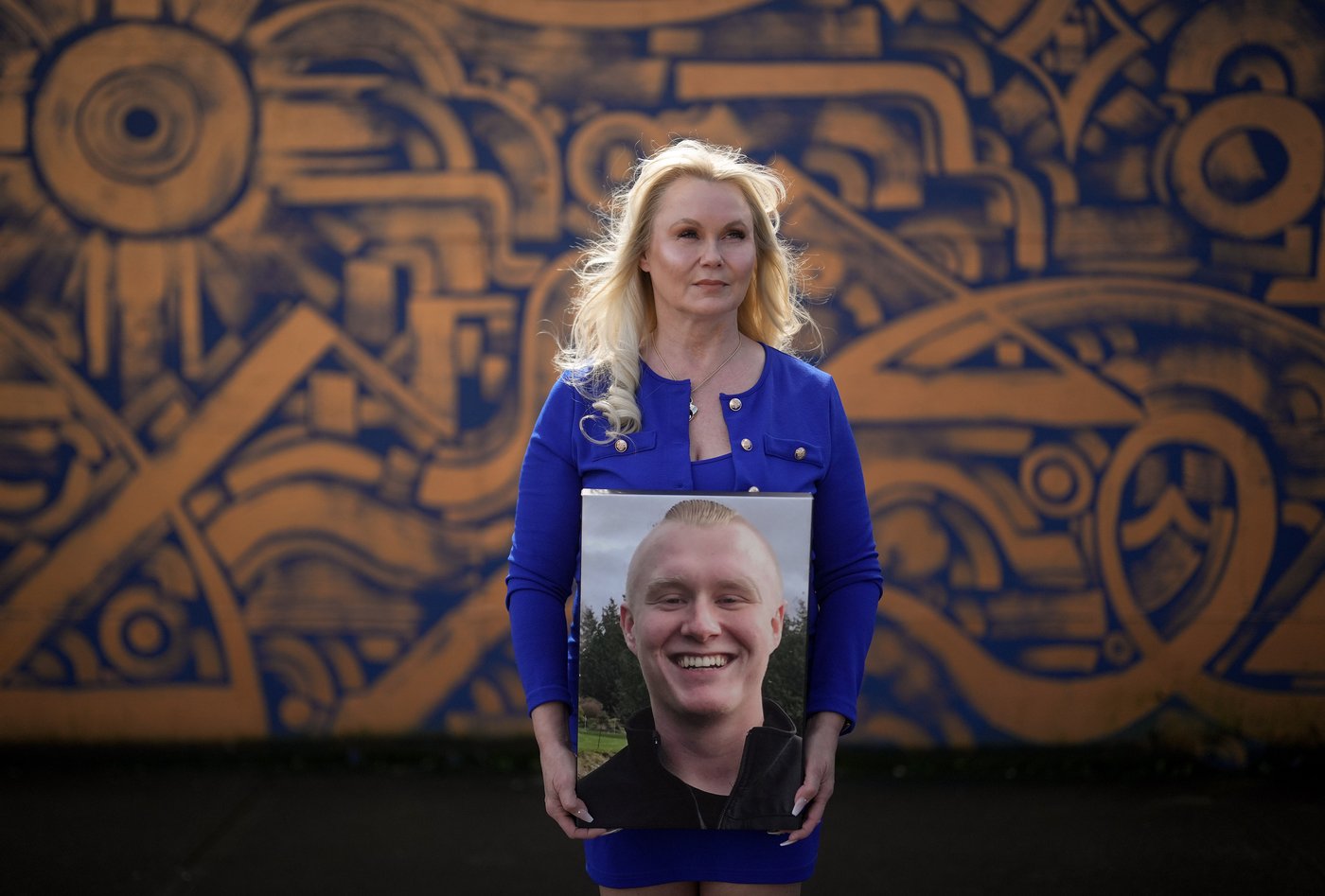 Michelle Jansen holds a photo of her late son, Brandon Jansen, who died of a fentanyl overdose at a rehab facility days before his 21st birthday in 2016, while posing for a photograph in Maple Ridge, B.C., on Friday, March 20, 2026. THE CANADIAN PRESS/Darryl Dyck