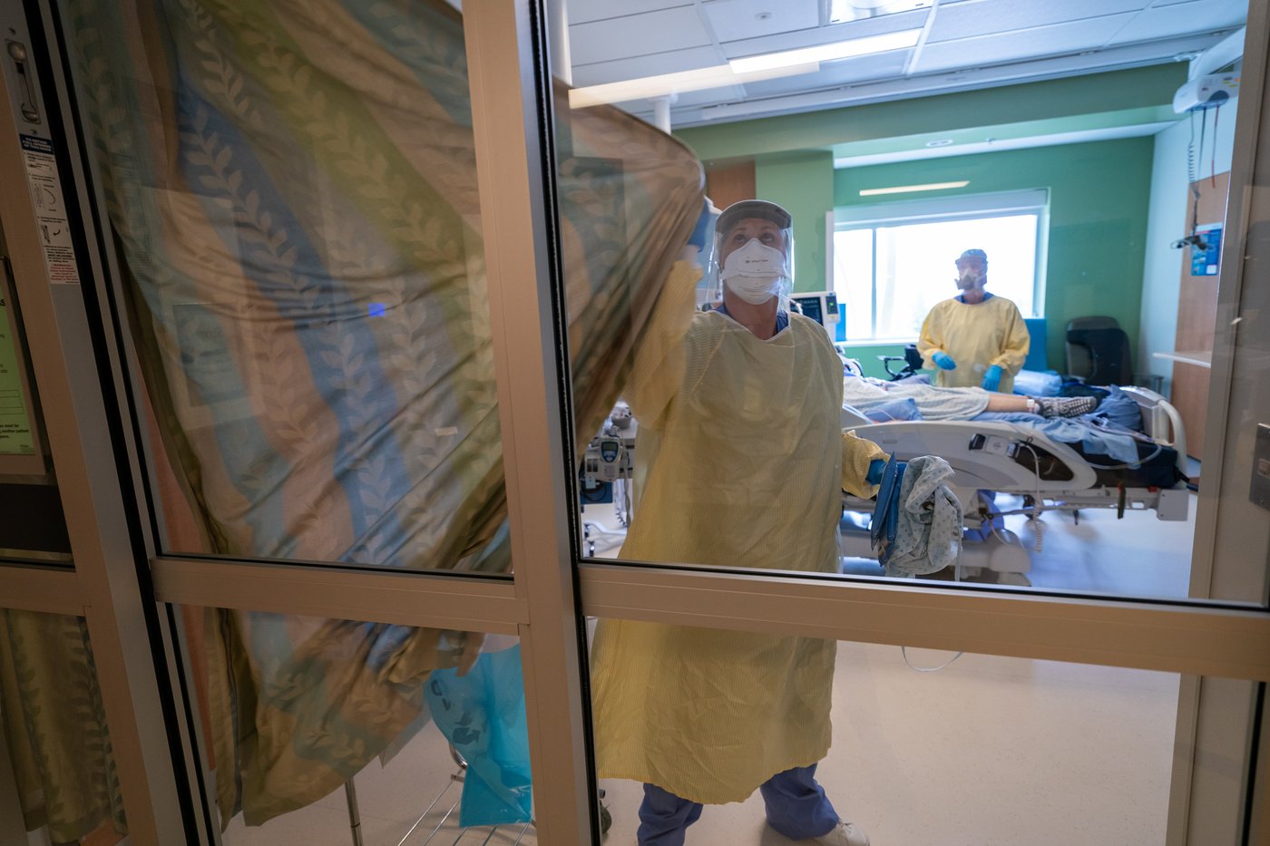 Nurses close the curtains of a patients room in the Intensive Care Unit at Surrey Memorial Hospital in Surrey, B.C., Friday, June 4, 2021. THE CANADIAN PRESS/Jonathan Hayward