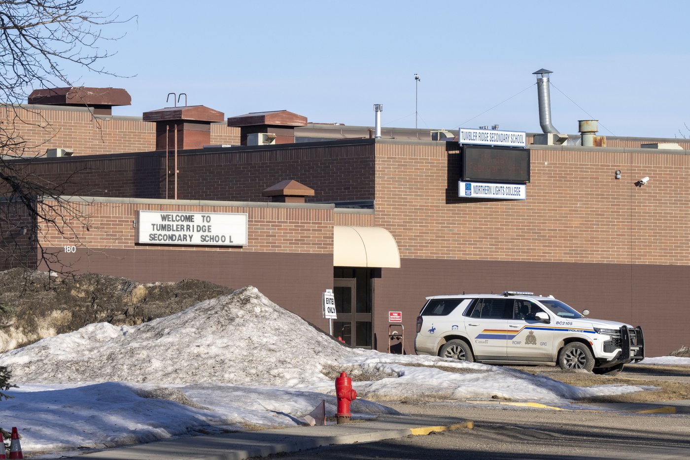 An RCMP vehicle sits outside Tumbler Ridge Secondary School in Tumbler Ridge, B.C., on Friday, Feb. 13, 2026. THE CANADIAN PRESS/Christinne Muschi
