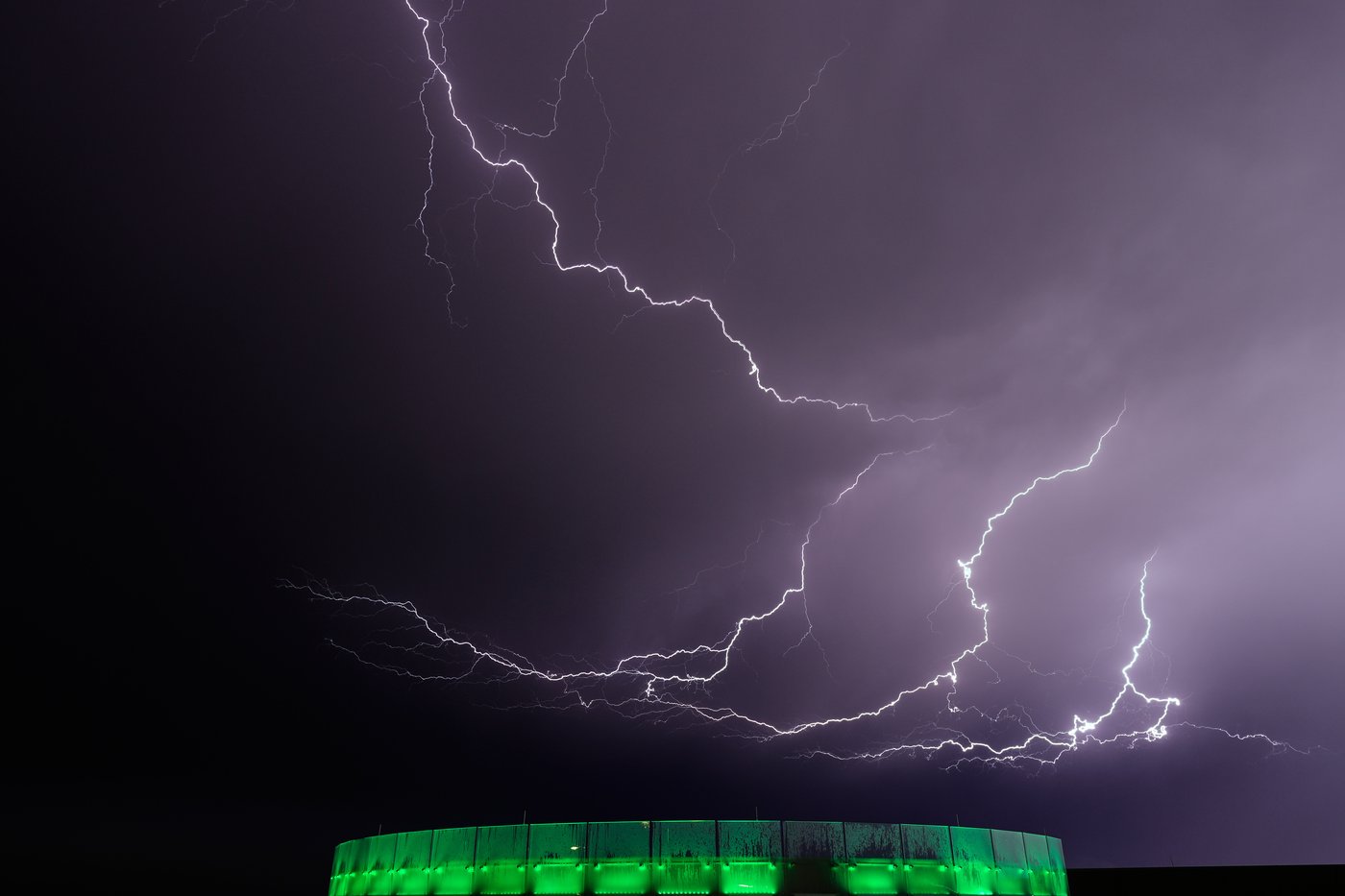 Lightning flashes beyond an office building as a thunderstorm passes in the distance, Monday, April 13, 2026, in Lenexa, Kan. THE CANADIAN PRESS/AP-Charlie Riedel