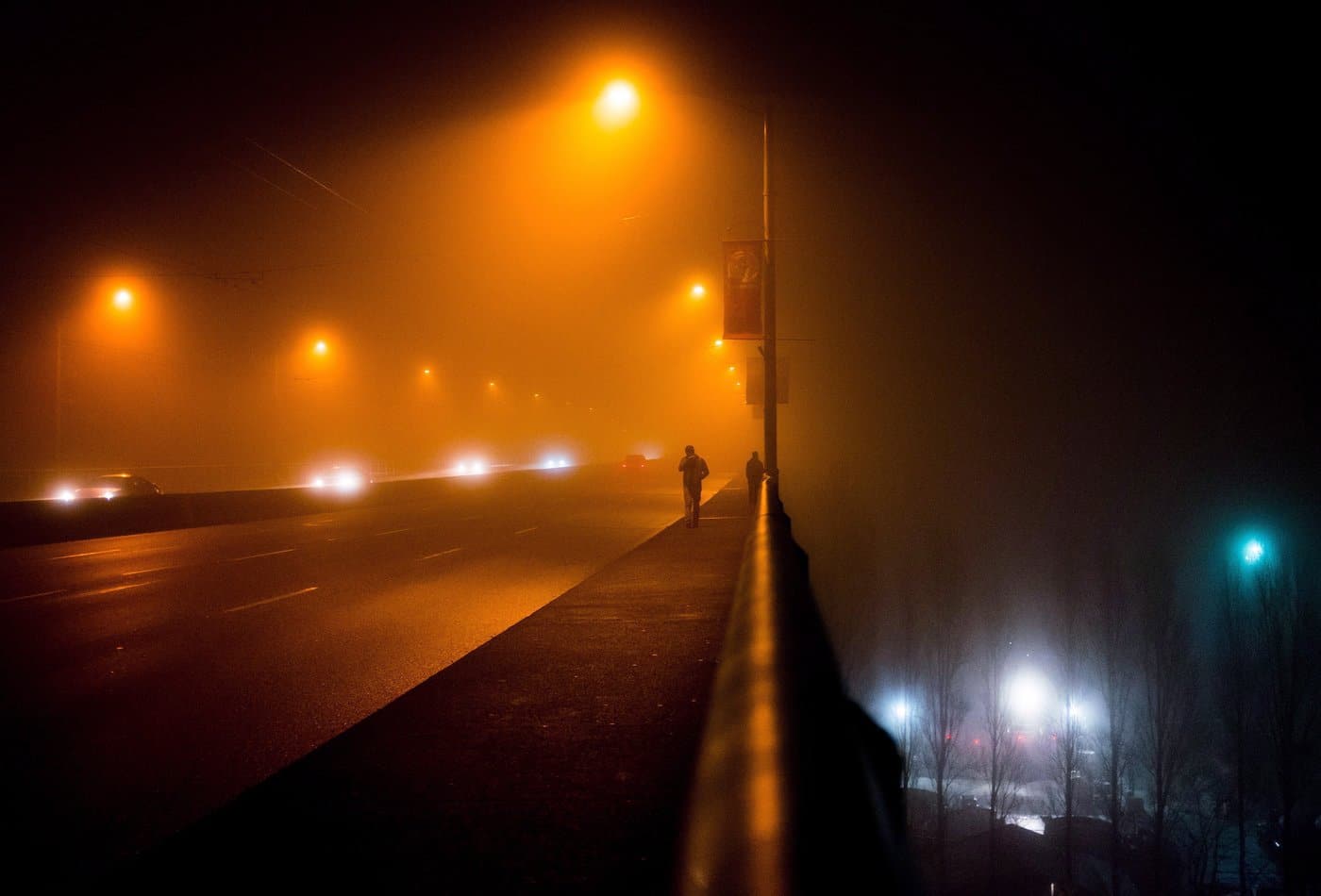 Two men are silhouetted while walking across the Granville Street Bridge as dense fog fills the air in Vancouver, B.C., on Saturday Jan. 2, 2016. THE CANADIAN PRESS/Darryl Dyck