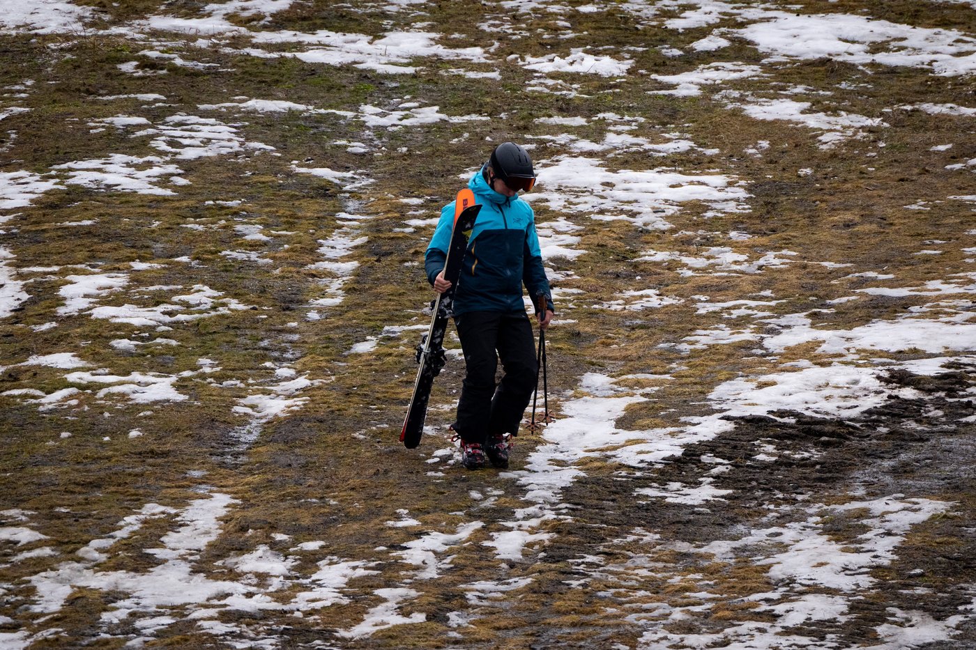 A skier walks down a patchy ski slope at Whistler, B.C., on Friday, Dec. 29, 2023. THE CANADIAN PRESS/Ethan Cairns