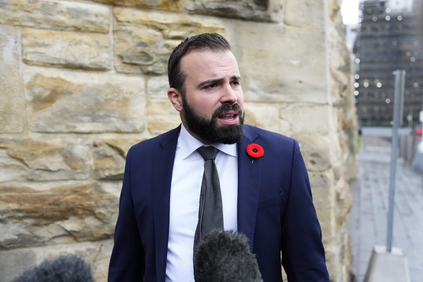 Conservative MP Aaron Gunn responds to journalists' questions before a meeting of the Conservative caucus on Parliament Hill in Ottawa on Wednesday, Nov. 5, 2025. THE CANADIAN PRESS/Justin Tang