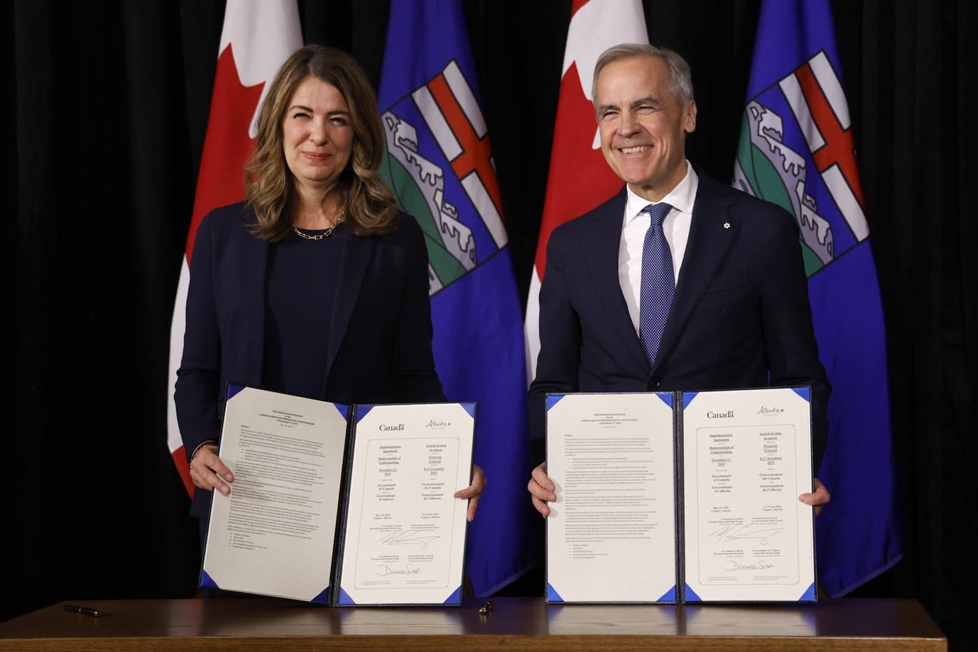 Prime Minister Mark Carney participates in a signing ceremony with Alberta Premier Danielle Smith in Calgary on Friday, May 15, 2026. THE CANADIAN PRESS/Jeff McIntosh