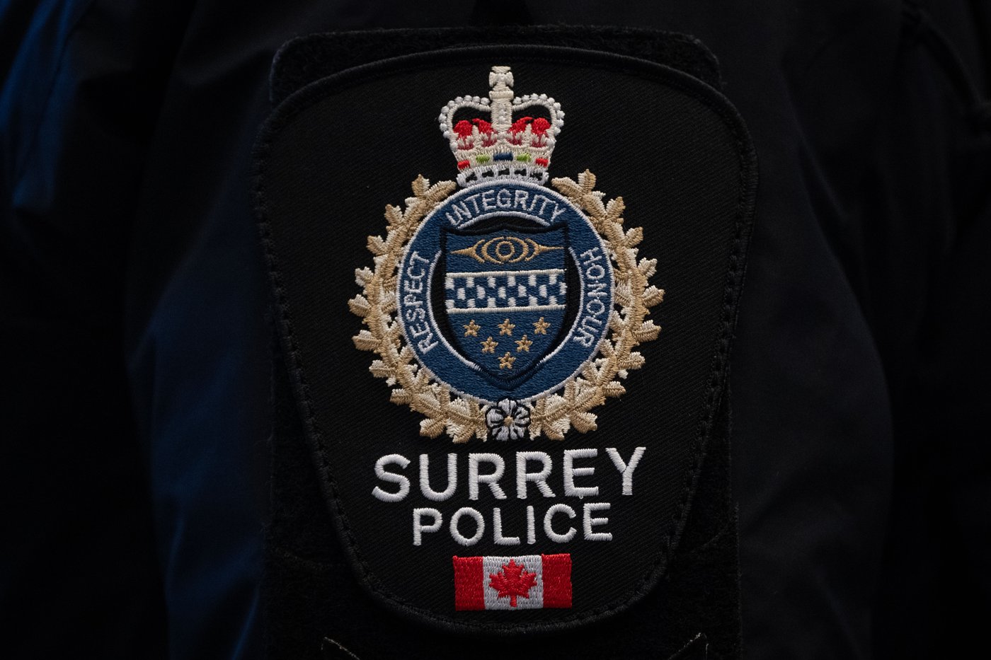 A Surrey Police patch is worn by an officer at RCMP "E" Division headquarters in Surrey, B.C., on Thursday, Feb. 19, 2026. THE CANADIAN PRESS/Ethan Cairns