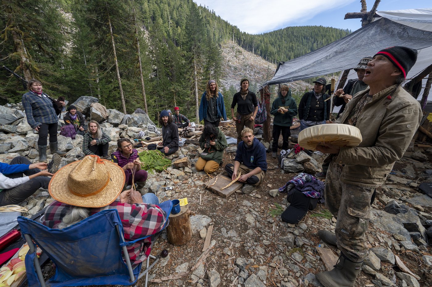 Protesters sing as they guard an area of a logging cut block called “Heli Camp” in the Fairy Creek logging area near Port Renfrew, B.C. Monday, Oct. 4, 2021. The group was protesting the logging of the area's old-growth forest. THE CANADIAN PRESS/Jonathan Hayward