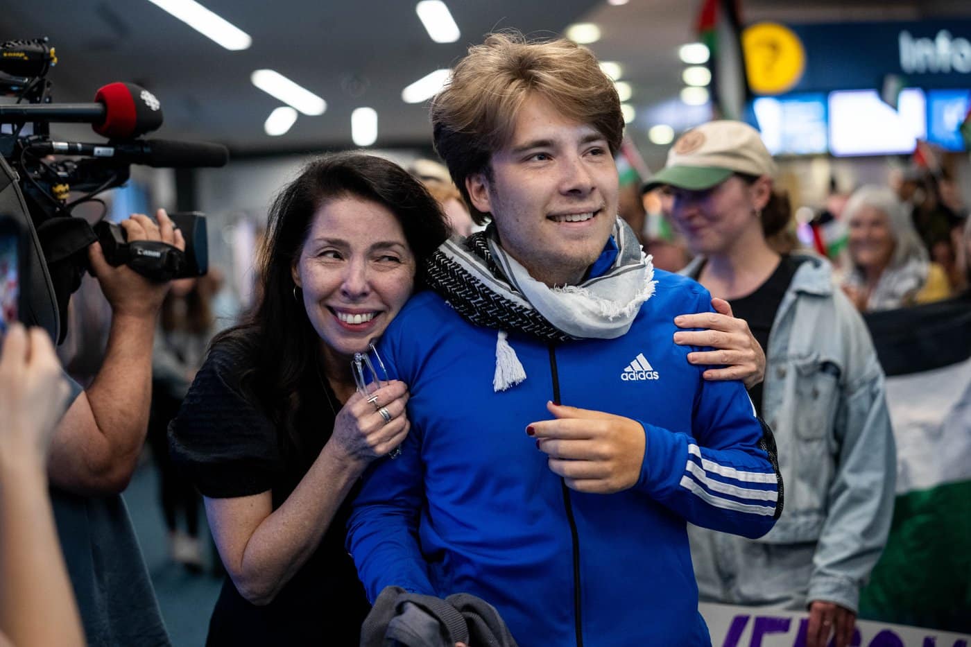 Sebastian Tow, right, member of the Gaza flotilla, reunites with his mother Anita Wittenberg as he arrives at the Vancouver International Airport in Richmond B.C., on Sunday, May 24, 2026. THE CANADIAN PRESS/Ethan Cairns