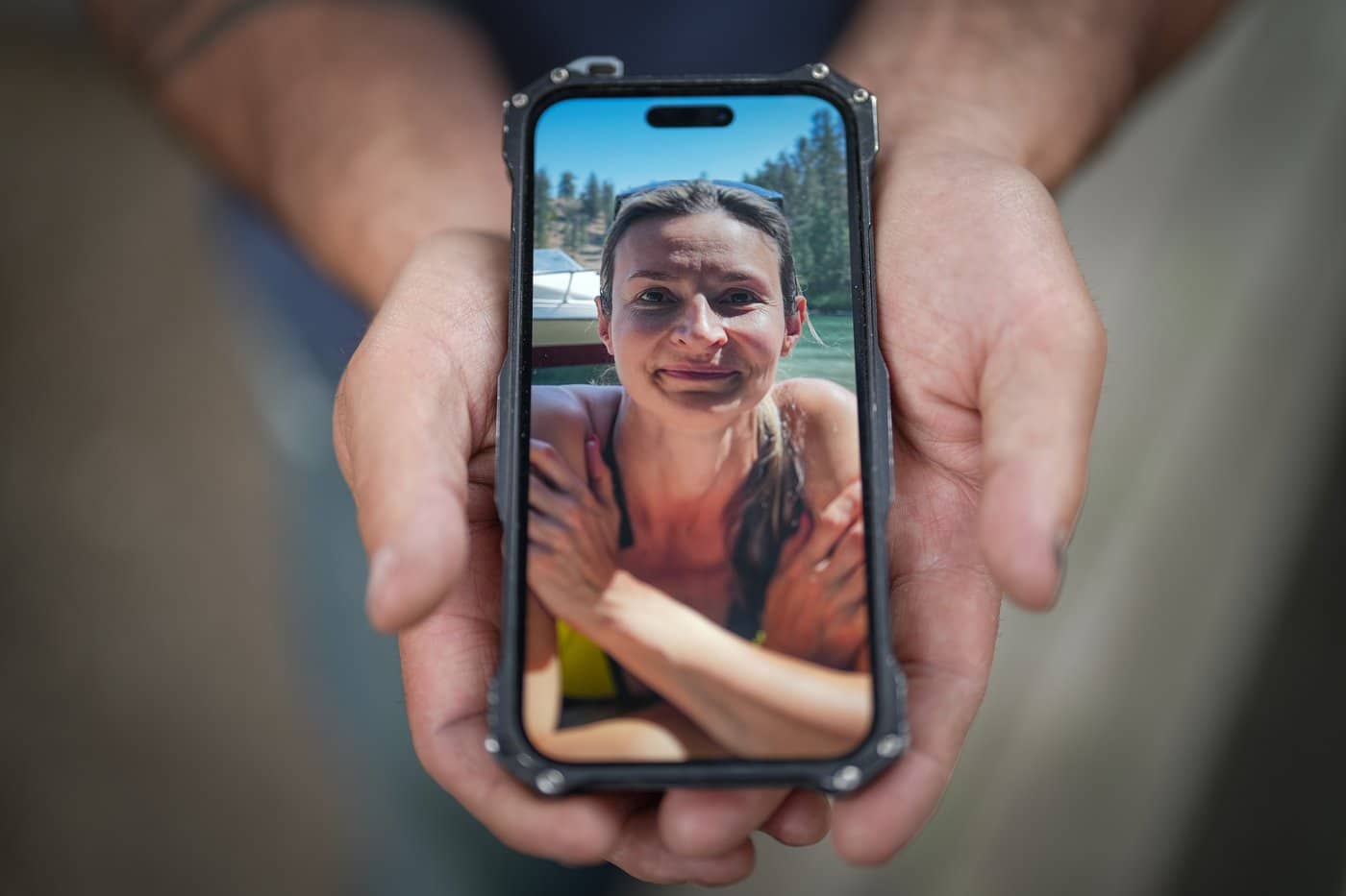 Jason Gaudreault, whose partner Tatjana Stefanski was found dead on April 14, 2024, after disappearing a day earlier, shows a photograph of her on his phone, in Lumby, B.C., on Monday, May 13, 2024. THE CANADIAN PRESS/Darryl Dyck