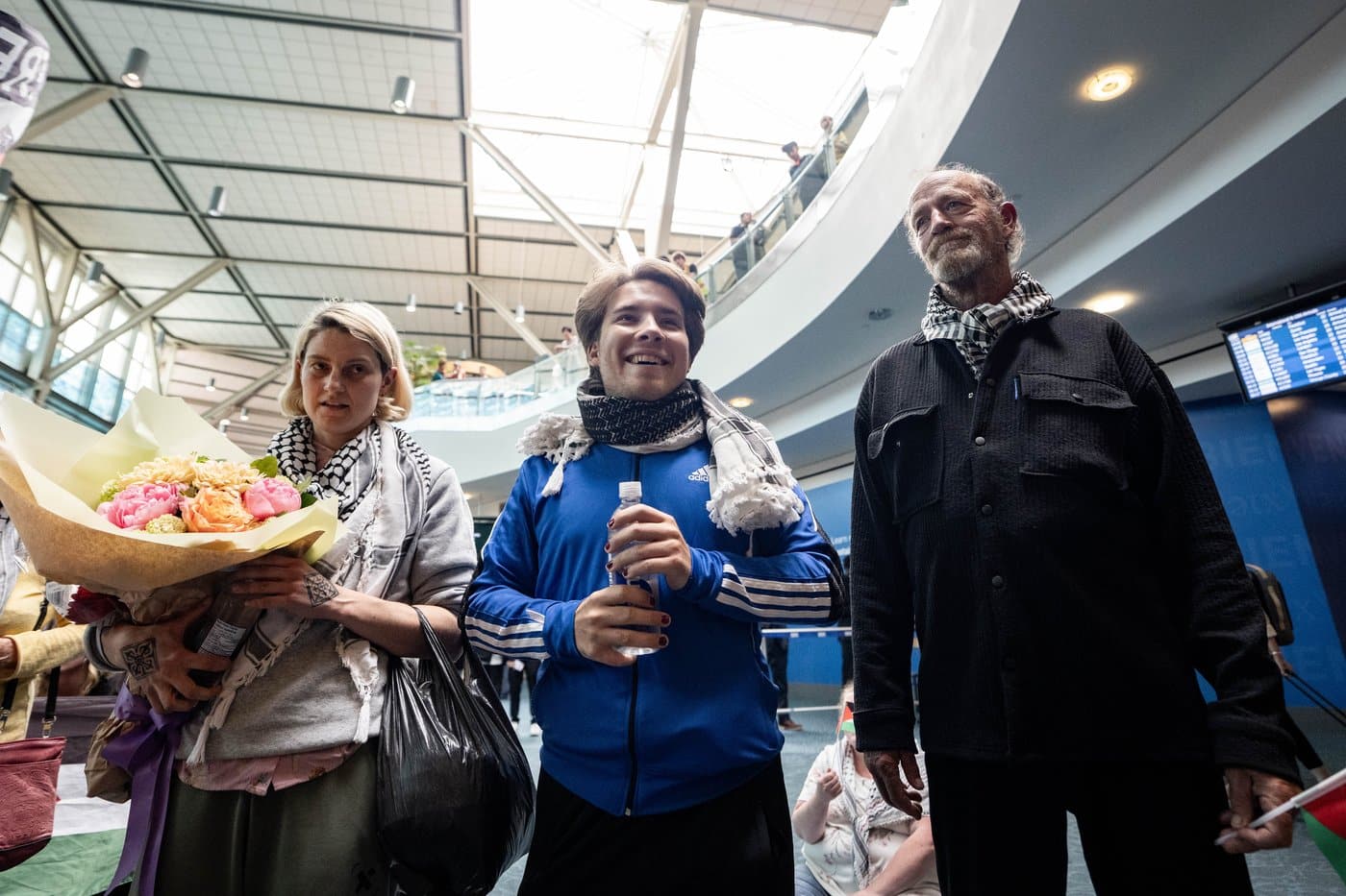 Mary Grace Mathisen, left to right, Sebastian Tow, and Michael France, members of the Gaza-bound flotilla which was detained by Israel, arrive at the Vancouver International Airport in Richmond, B.C., on Sunday, May 24, 2026. THE CANADIAN PRESS/Ethan Cairns